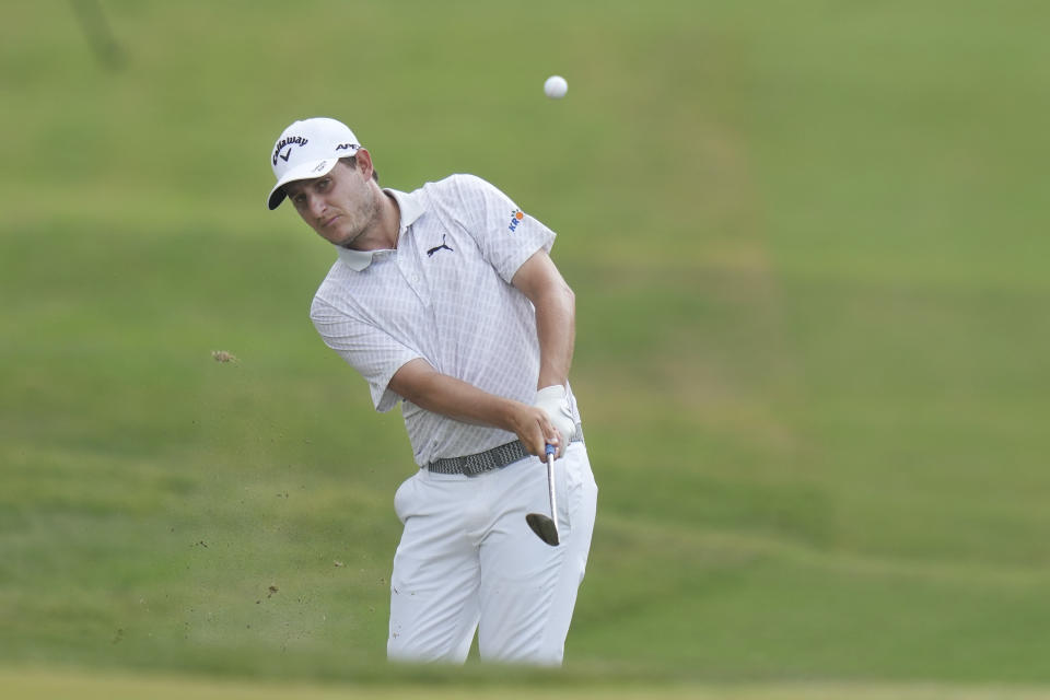 FILE - Emiliano Grillo, of Argentina, hits an approach shot on the 18th hole during the final round of the Charles Schwab Challenge golf tournament at Colonial in Fort Worth, Texas, May 28, 2023. Grillo had to go to playoff last year after a double boey, when his wayward tee shot went into the flowing water of a small concrete drainage canal to the right of the 18th fairway. The ball finally came to rest against a rock in the middle of the flow about 150 yards downstream. (AP Photo/LM Otero, File)