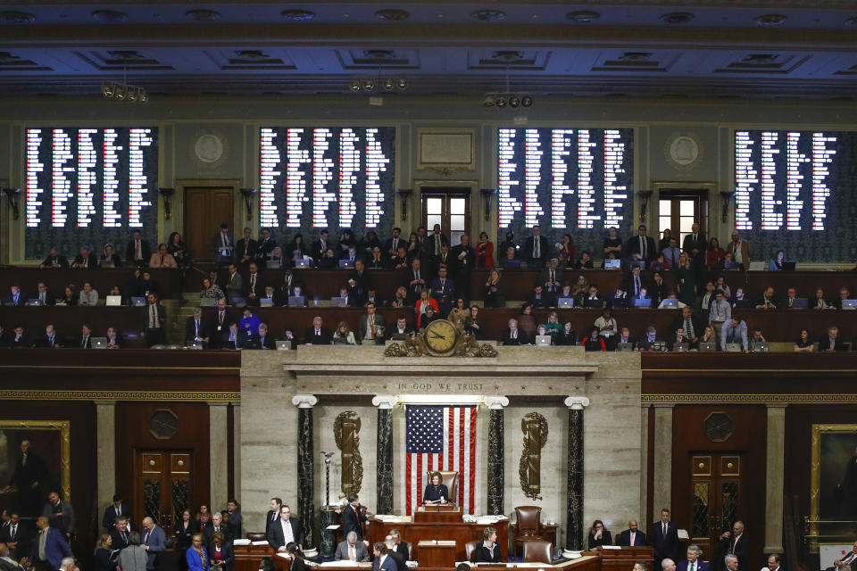 House members vote as House Speaker Nancy Pelosi of Calif., stands on the dais, during a vote on article II of impeachment against President Donald Trump, Wednesday, Dec. 18, 2019, on Capitol Hill in Washington. (AP Photo/Patrick Semansky)