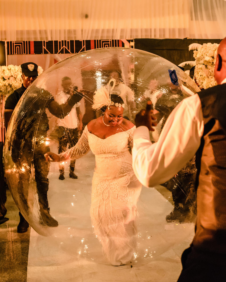 Bride 'walks' down aisle in giant bubble. Photo: Caters.