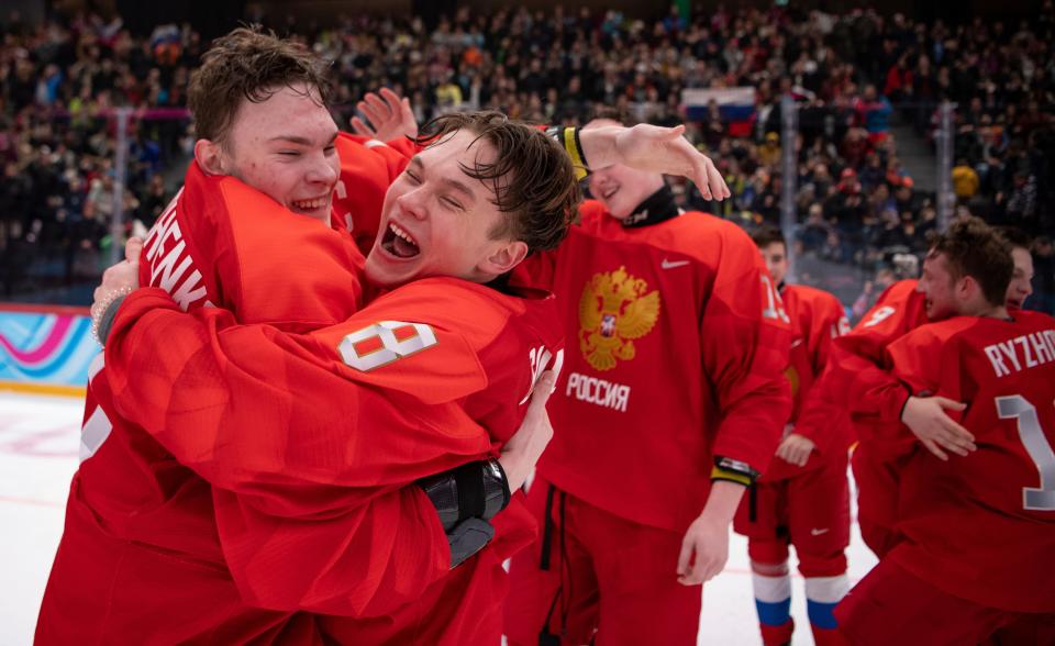 Russian ice hockey players Ivan Miroshnichenko, left, and Mikhail Gulyayev (8) celebrate their victory against the United States in an ice hockey match of the 2020 Winter youth Olympic Games in Lausanne, Switzerland, Wednesday, Jan. 22, 2020. (Joel Marklund for OIS via AP)