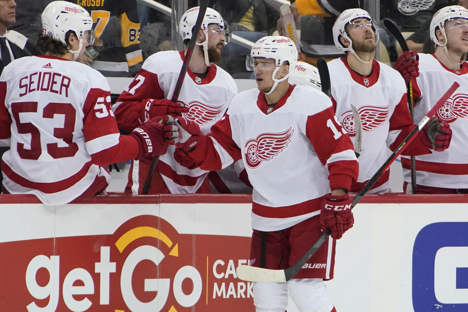 Detroit Red Wings' Jakub Vrana (15) returns to the bench after scoring during the second period of an NHL hockey game against the Pittsburgh Penguins in Pittsburgh, Sunday, March 27, 2022. (AP Photo/Gene J. Puskar)
