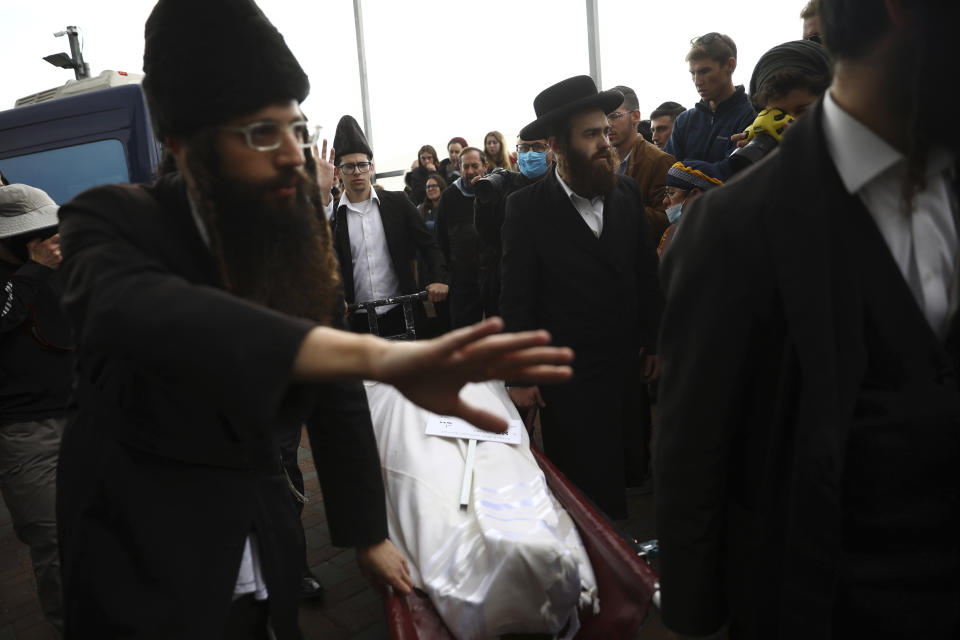 The body of Eliyahu Kay, a 26-year-old immigrant to Israel from South Africa, is carried during his funeral the day after he was killed when a Palestinian man opened fire in the Old City of Jerusalem, Monday, Nov. 22, 2021, in Jerusalem. (AP Photo/Oded Balilty)