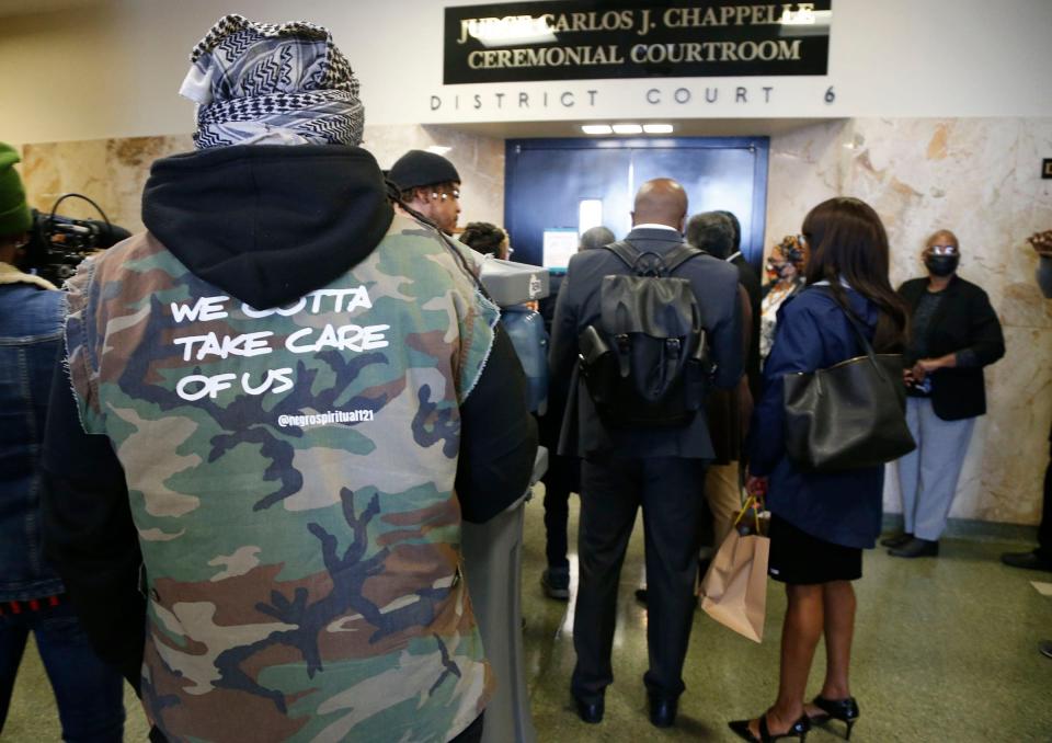 People wait for a hearing at the Tulsa County Courthouse on May 2, 2022, in Tulsa, Okla.