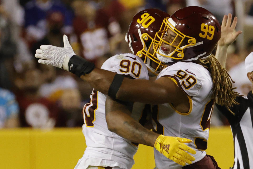 Football Team defensive end Chase Young (99) celebrates wit Washington Football Team defensive end <a class="link " href="https://sports.yahoo.com/nfl/players/31858" data-i13n="sec:content-canvas;subsec:anchor_text;elm:context_link" data-ylk="slk:Montez Sweat;sec:content-canvas;subsec:anchor_text;elm:context_link;itc:0">Montez Sweat</a> (90) Credit: Geoff Burke-USA TODAY Sports