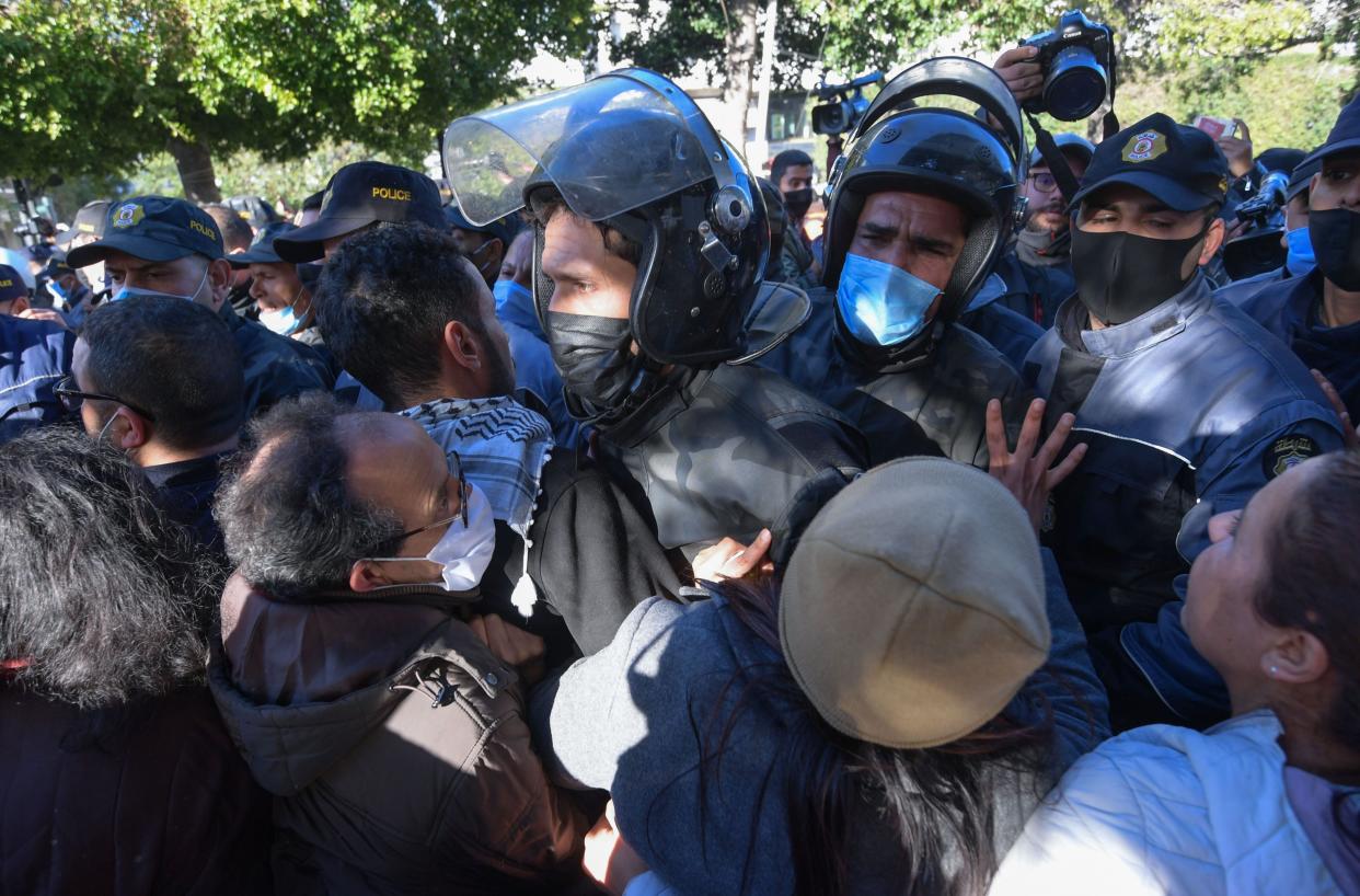 <p>Security forces clash with protesters in Tunis</p> (AFP via Getty Images)