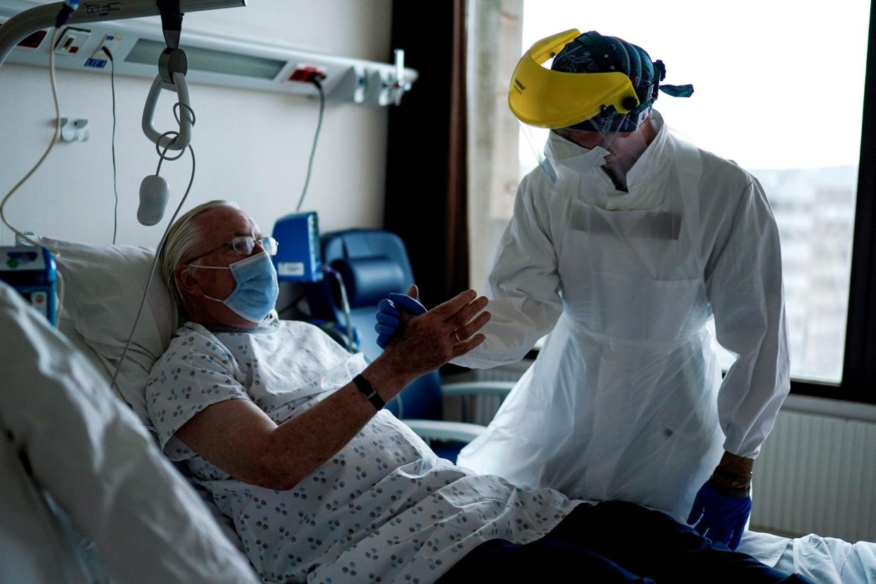 Doctor speaks to patient in the coronavirus unit at the Erasme Hospital in Brussels: AFP via Getty Images