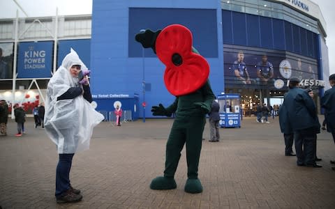 A poppy mascot outside the stadium as part of remembrance commemorations before the match  - Credit: Action Images via Reuters/Carl Recine