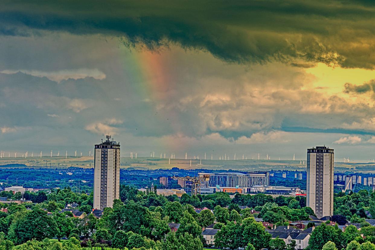 Glasgow, Scotland, UK. 18th June, 2024: UK Weather: Wet and hot sunny day in the city in the city saw strange sky with a rainbow over the towers of scotstoun and the queen elizabeth hospital; . Credit Gerard Ferry/Alamy Live News