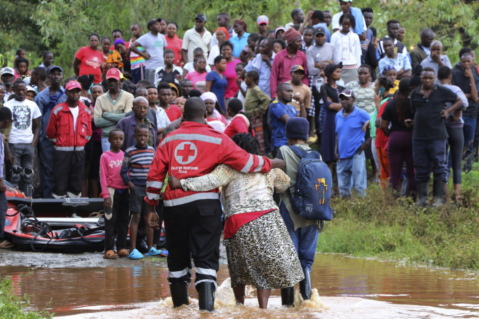 A woman is rescued from her flooded house by Red Cross workers in Githurai area of Nairobi, Kenya, Wednesday, April 24, 2024. Heavy rains pounding different parts of Kenya have led to dozens of deaths and the displacement of tens of thousands of people, according to the U.N., citing the Red Cross. (AP Photo/Edaward Odero)