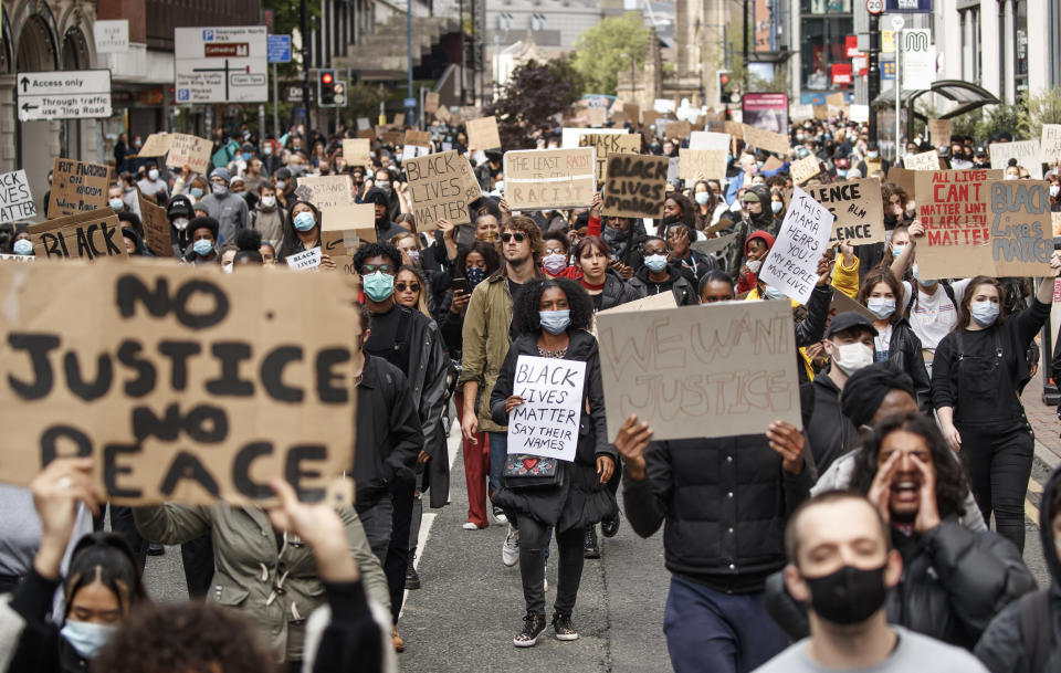 People take part in a Black Lives Matter protest rally in Manchester, England, Sunday, June 7, 2020, in response to the recent killing of George Floyd by police officers in Minneapolis, USA, that has led to protests in many countries and across the US. (Danny Lawson/PA via AP)