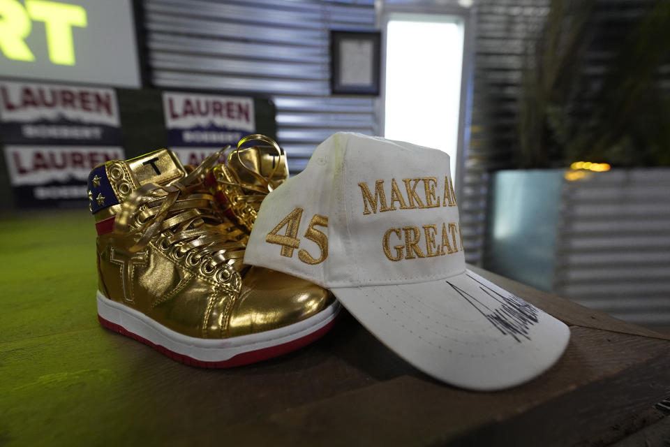 A pair of items from former President Doanld Trump sits on stage as Rep. Lauren Boebert, R-Colo., speaks with supporters during a primary election watch party Tuesday, June 25, 2024, in Windsor, Colo. (AP Photo/David Zalubowski)