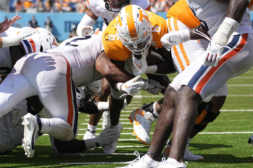 Tennessee running back Dylan Sampson (6) rushes past Virginia linebacker Stevie Bracey, left, for a touchdown in the second half of an NCAA college football game Saturday, Sept. 2, 2023, in Nashville, Tenn. (AP Photo/George Walker IV)