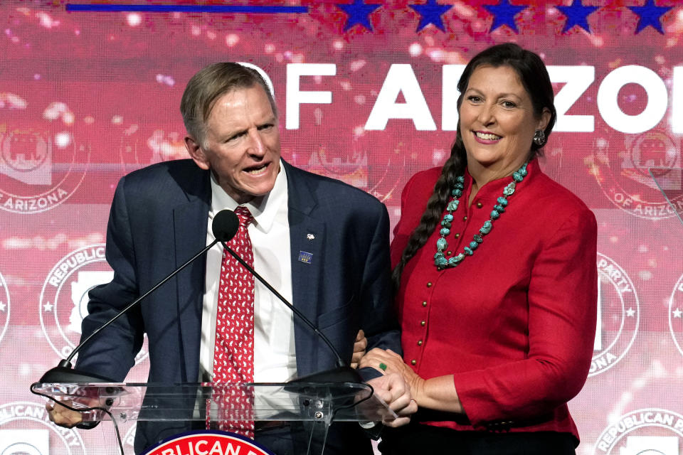 Rep. Paul Gosar, left, R-Ariz., speaks as his wife Maude Gosar, right, stands at his side at the Republican watch party in Scottsdale, Ariz., Tuesday, Nov. 8, 2022. (AP Photo/Ross D. Franklin)