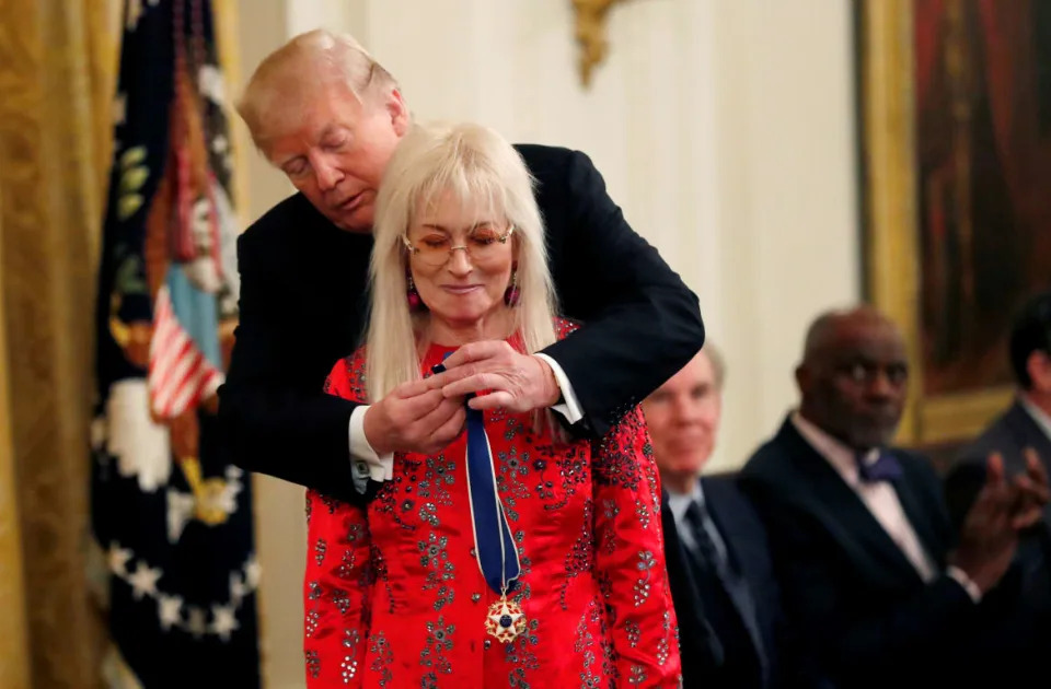 Donald Trump putting a Presidential Medal of Freedom on Miriam Adelson