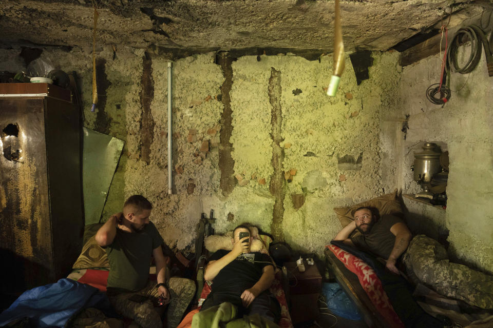 Ukrainian servicemen rest in a basement between fightings with Russian forces at the frontline in Kharkiv region, Ukraine, Wednesday, July 27, 2022. (AP Photo/Evgeniy Maloletka)