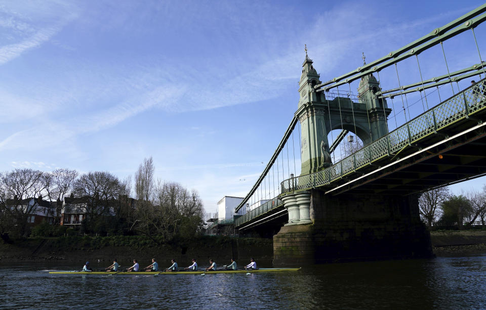 The Cambridge men's team pass under Hammersmith Bridge during a training session on the River Thames in London, Tuesday March 26, 2024. Jumping into London’s River Thames has been the customary celebration for members of the winning crew in the annual Boat Race between storied English universities Oxford and Cambridge. Now researchers say it comes with a health warning.(John Walton/PA via AP)