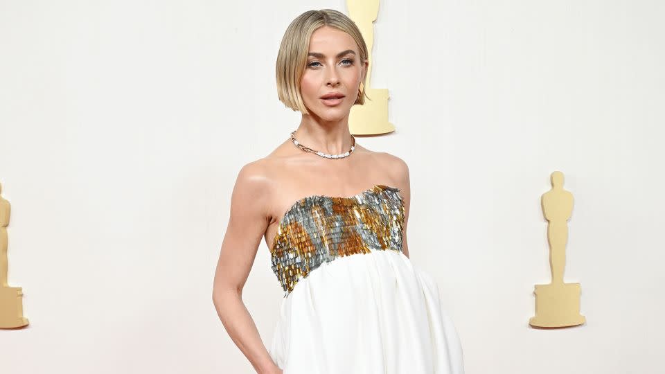 Preshow co-host Julianne Hough arrived in a strapless Alexandre Vauthier number with an embellished silver and gold bust and flowy white pants so wide they looked like a gown. - Gilbert Flores/Variety/Getty Images