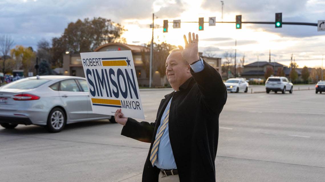 Meridian incumbent Mayor Robert Simison waves to motorists at the corner of Cherry Lane and Meridian Road on Election Day, Nov. 7, 2023.