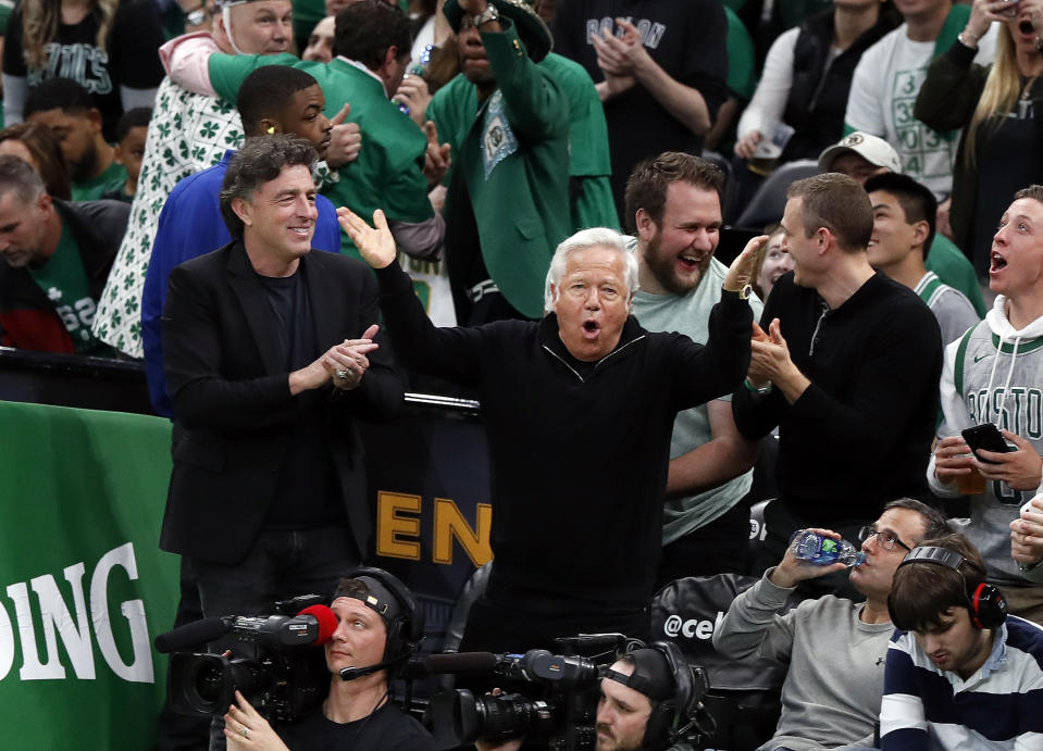 New England Patriots owner Robert Kraft, center, cheers on the Boston Celtics with Celtics owner Wyc Grousbeck, left, during the third quarter in Game 1 of a first-round NBA basketball playoff series between the Celtics and the Indiana Pacers, Sunday, April 14, 2019, in Boston. (AP Photo/Winslow Townson)