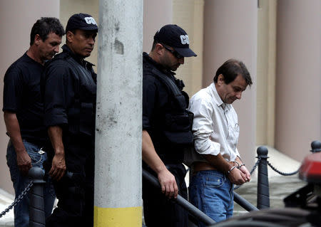 FILE PHOTO: Leftist Italian militant Cesare Battisti is escorted by Brazilian federal police officers as he leaves the Federal Justice building in Rio de Janeiro, Brazil December 10, 2009. REUTERS/Sergio Moraes/File Photo