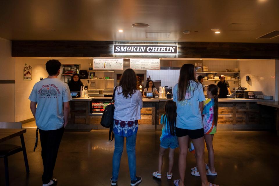 People wait in line at of Smokin Chikin at Assembly Food Hall  in Nashville , Tenn., Monday, May 29, 2023.