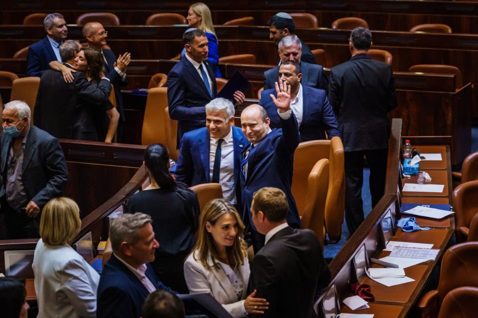 Naftali Bennett waves to crowd at Knesset.