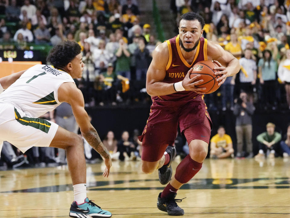 Iowa State guard Jaren Holmes (13) drives to the basket past Baylor guard Keyonte George (1) in the first half of an NCAA college basketball game, Saturday, March 4, 2023, in Waco, Texas. (Chris Jones/Waco Tribune-Herald via AP)