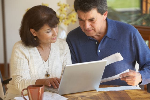 Senior Hispanic couple paying bills