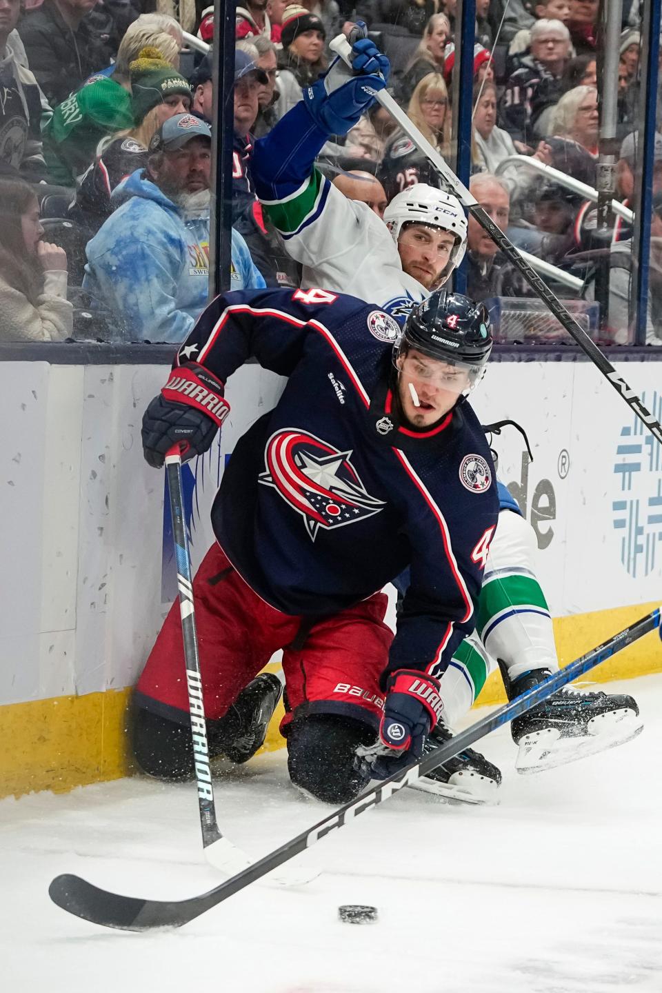 Jan 15, 2024; Columbus, Ohio, USA; Columbus Blue Jackets center Cole Sillinger (4) collides with Vancouver Canucks defenseman Carson Soucy (7) during the third period of the NHL hockey game at Nationwide Arena. The Blue Jackets won 4-3 in a shootout.