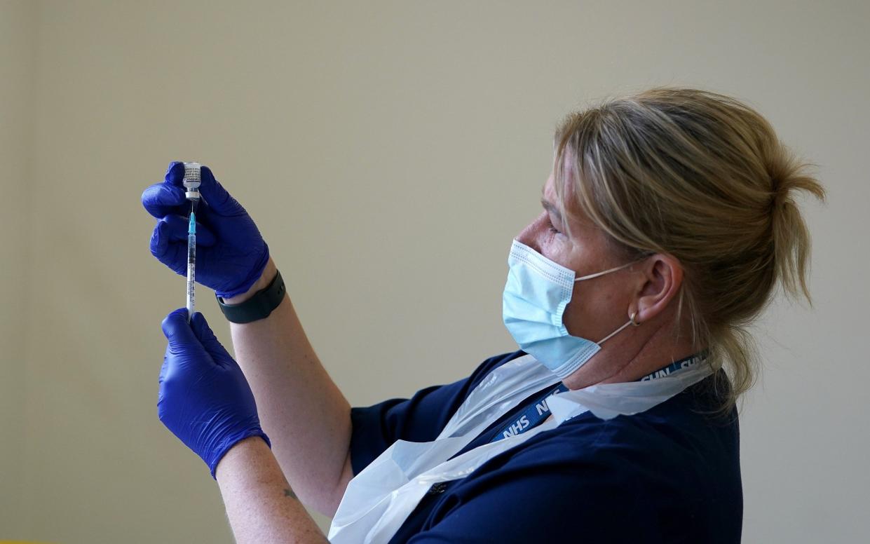 Nurse with jab - Martin Rickett/PA Wire