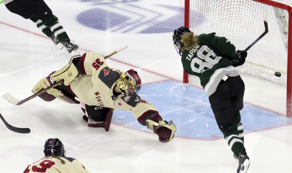 Boston forward Susanna Tapani (88) scores against Montreal goalie Ann-Renee Desbiens (35) during overtime of a PWHL playoff hockey game Tuesday, May 14, 2024, in Lowell, Mass. (AP Photo/Mark Stockwell)