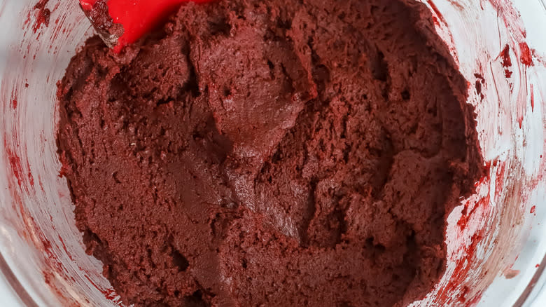 brown dough in bowl with rubber spatula