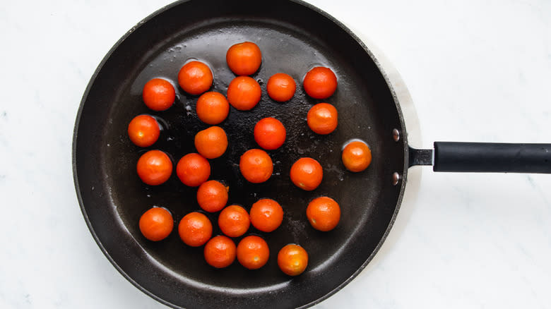 Cherry tomatoes frying in pan