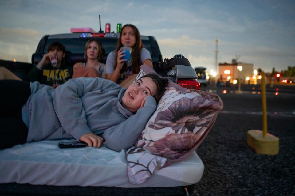 Kismet Kelley, of Farmington, lays on her side while watching "Despicable Me 4" with (right to left) Charisma Kelley, Kharma Kelley and Frank Silvagi, all of Farmington at the Ford-Wyoming Drive-In in Dearborn on Tuesday, July 16, 2024.