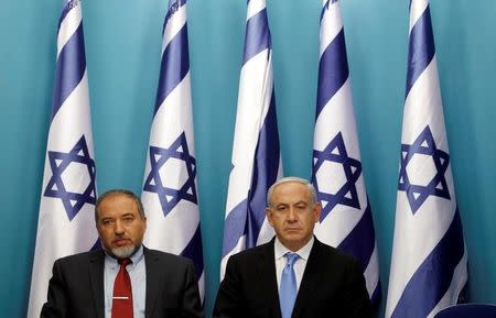 Israel's Prime Minister Benjamin Netanyahu (R) sits next to Foreign Minister Avigdor Lieberman after delivering a statement in Jerusalem November 21, 2012. REUTERS/Baz Ratner/File Photo