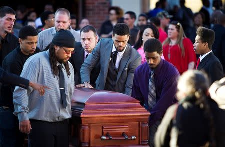 Uncle Turin Carter (C) and pallbearers wheel the casket of Tony Robinson, Jr. during Robinson's funeral at Madison East High School in Madison, Wisconsin, March 14, 2015. REUTERS/Ben Brewer