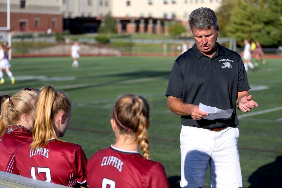 Portsmouth High School girls soccer coach Mickey Smith talks to his team during a break a Division I game against Goffstown.