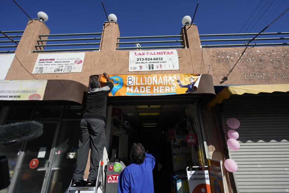 A banner is hung outside the Las Palmitas Mini Market where the winning Powerball lottery ticket was sold in downtown Los Angeles, Thursday, July 20, 2023. The winning ticket for the Powerball jackpot is worth an estimated $1.08 billion and is the sixth largest in U.S. history and the third largest in the history of the game. (AP Photo/Marcio Jose Sanchez)