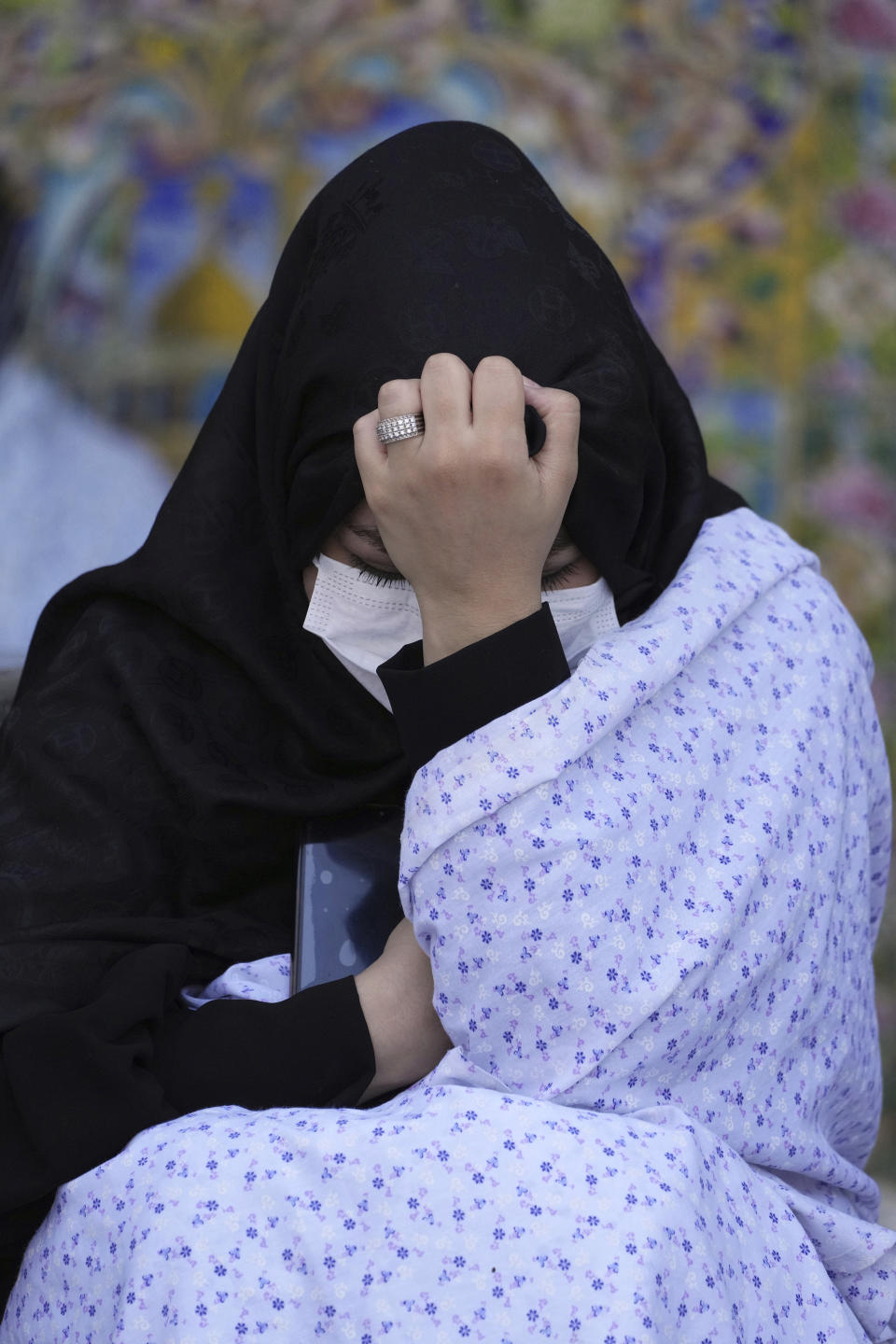 A woman mourns in an annual procession commemorating Ashoura which marks the death anniversary of Imam Hussein, the grandson of Prophet Muhammad, who was killed with 72 of his companions in the 7th century in the Battle of Karbala in present-day Iraq, in Tehran, Iran, Monday, Aug. 8, 2022. (AP Photo/Vahid Salemi)