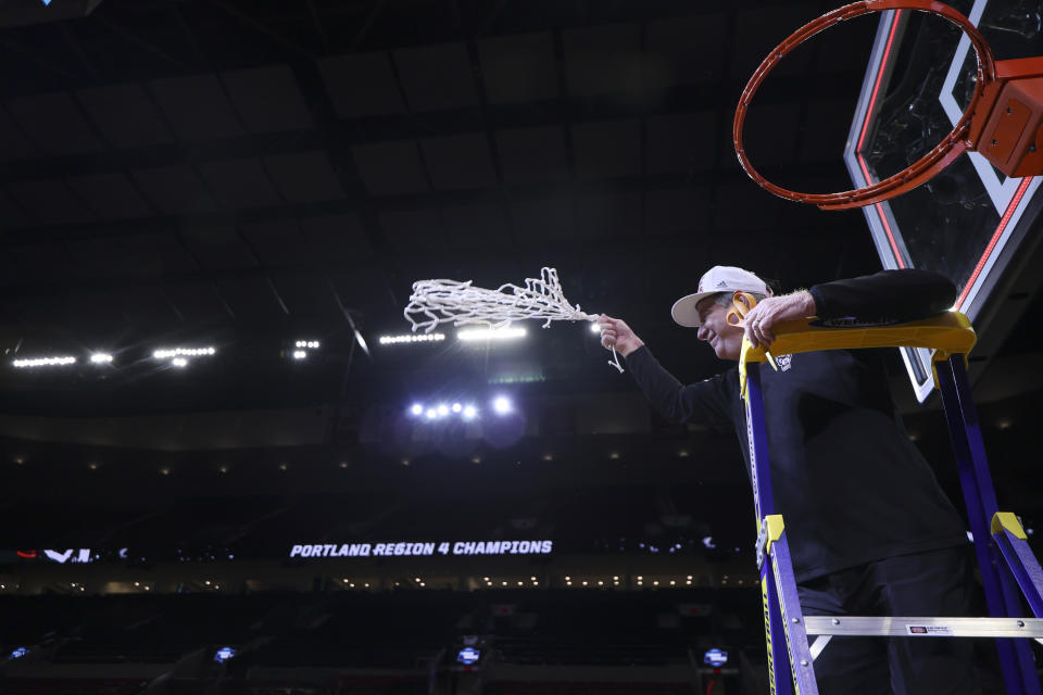 North Carolina State coach Wes Moore holds the net after the team's win against Texas in an Elite Eight college basketball game in the women's NCAA Tournament, Sunday, March 31, 2024, in Portland, Ore. North Carolina State won 76-66. (AP Photo/Howard Lao)