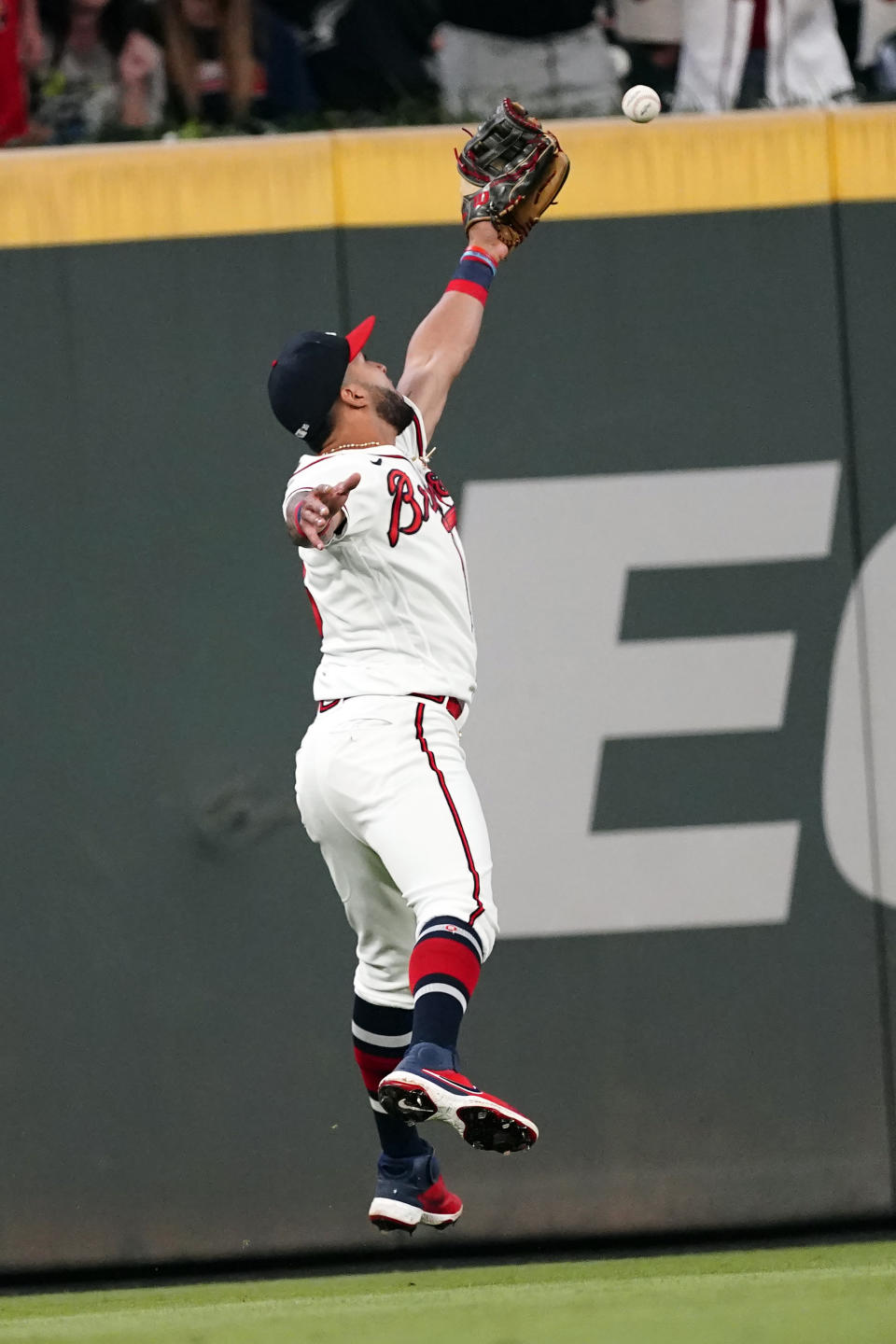 A flyball from Philadelphia Phillies' Matt Vierling gets past Atlanta Braves left fielder Eddie Rosario (8) in the ninth inning of a baseball game Tuesday, Sept. 28, 2021, in Atlanta. Rosario was charged with an error. (AP Photo/John Bazemore)