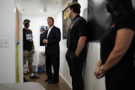 Former U.S. Sen. Dean Heller, second from left, tours the home of Michael Clark, left, at Share Village Las Vegas after announcing a bid for governor of Nevada, Monday, Sept. 20, 2021, in Las Vegas. (AP Photo/John Locher)