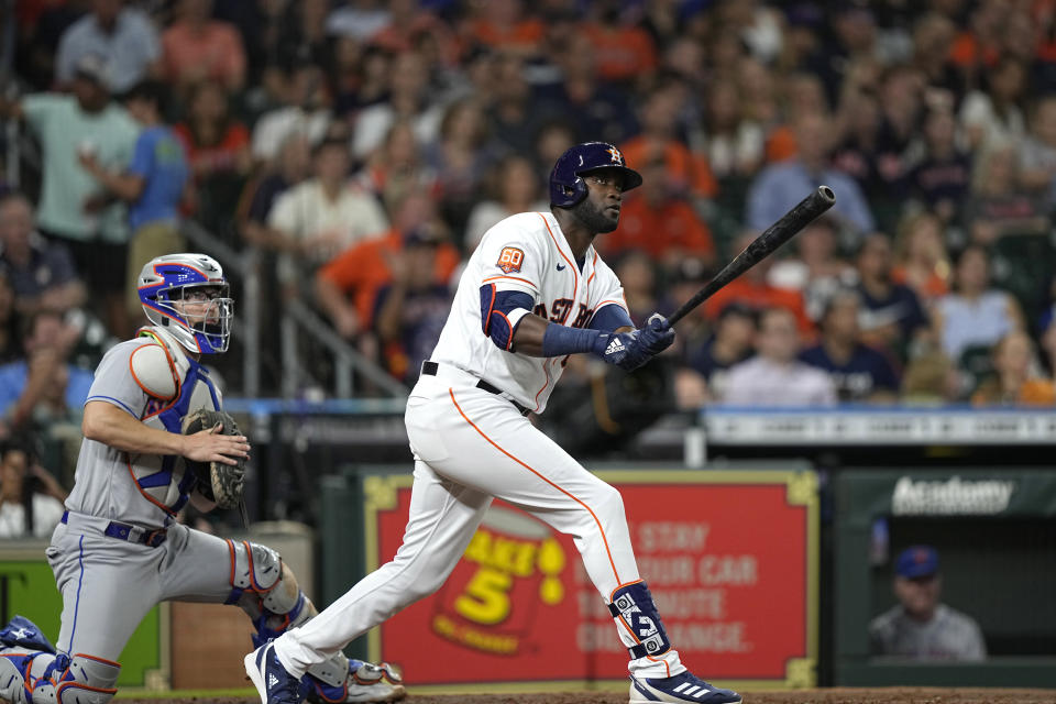 Houston Astros' Yordan Alvarez, right, watches his two-run home run along with New York Mets catcher Patrick Mazeika during the third inning of a baseball game Tuesday, June 21, 2022, in Houston. (AP Photo/David J. Phillip)