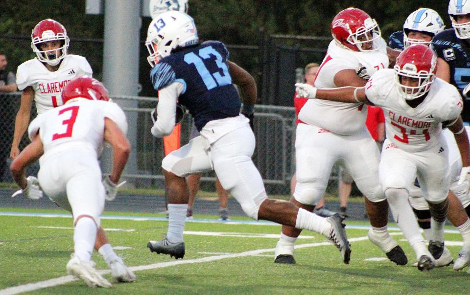 Bartlesville High School tailback Stefen Williams, No. 13, bursts through an open hole during football action against Claremore High School on Sept. 1, 2023.