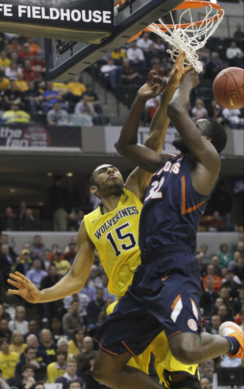 Michigan forward Jon Horford (15) blocks a shot by Illinois center Nnanna Egwu (32) in the first half of an NCAA college basketball game in the quarterfinals of the Big Ten Conference tournament Friday, March 14, 2014, in Indianapolis. (AP Photo/Kiichiro Sato)