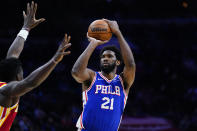 Philadelphia 76ers' Joel Embiid, right, goes up for a shot against Atlanta Hawks' Clint Capela during the second half of an NBA basketball game, Saturday, Oct. 30, 2021, in Philadelphia. (AP Photo/Matt Slocum)