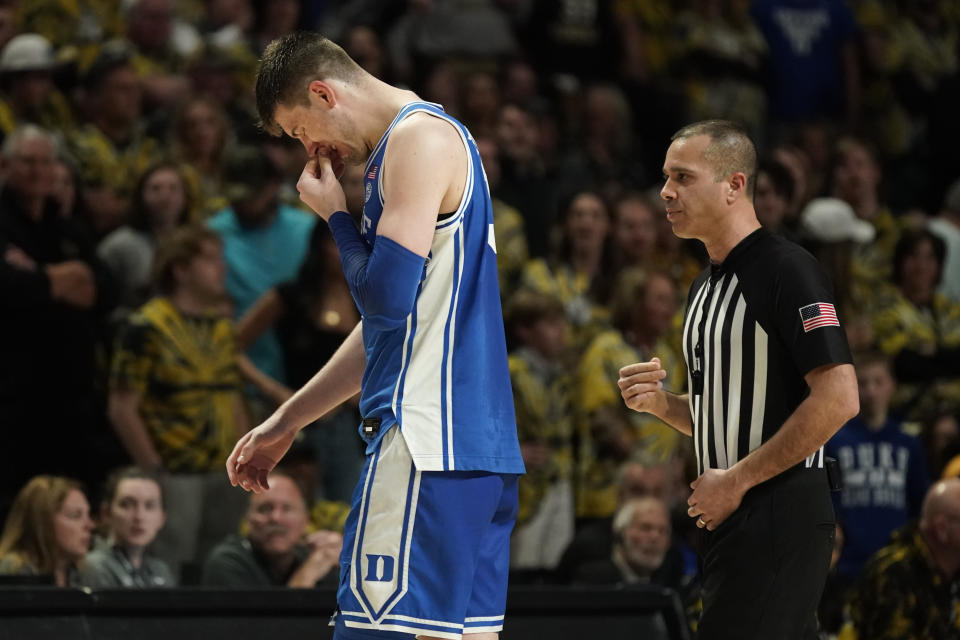 Duke's Kyle Filipowski holds his bloodied nose as he leaves the floor during the second half of an NCAA college basketball game against Wake Forest in Winston-Salem, N.C., Saturday, Feb. 24, 2024. (AP Photo/Chuck Burton)