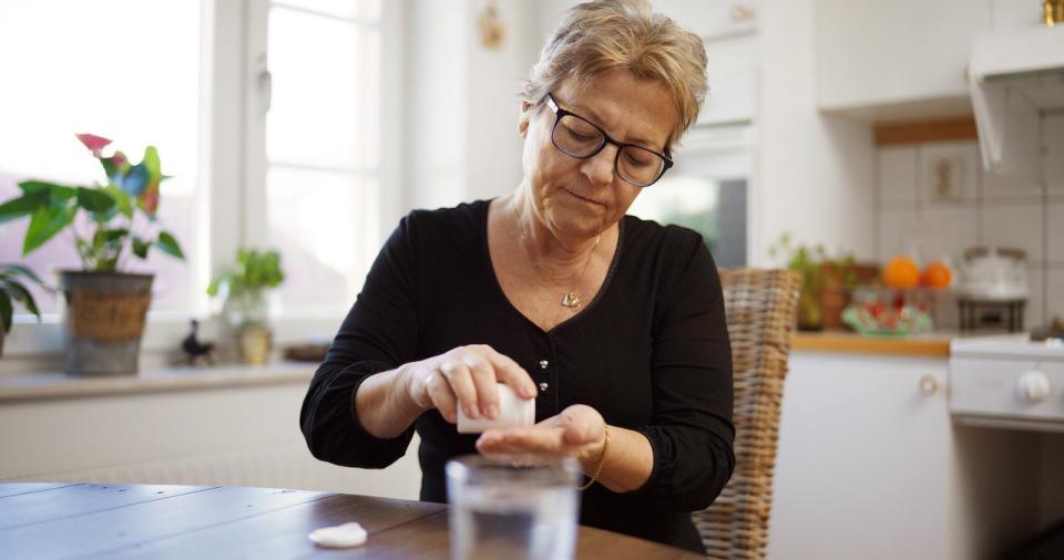 Older woman taking pills