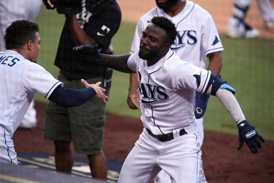 Oct 17, 2020; San Diego, California, USA; Tampa Bay Rays left fielder Randy Arozarena (56) celebrates with shortstop Willy Adames (1) his two run home run hit against the Houston Astros during the first inning in game seven of the 2020 ALCS at Petco Park. Mandatory Credit: Orlando Ramirez-USA TODAY Sports