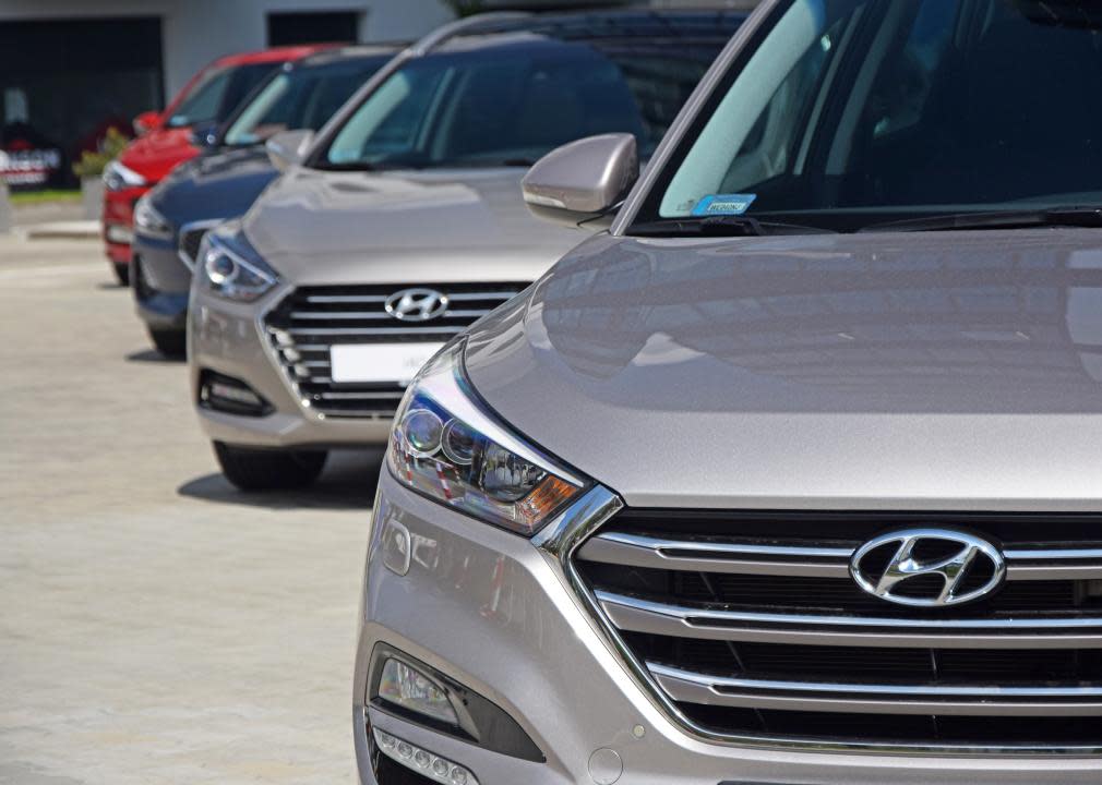 Hyundai cars parked in a row at a dealership.